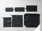 サラサデザインの黒色リバーシブルランドリーネット。ポリエステルとラテックス素材を使用し、フラットな形状で持ち手付き。