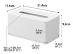 白色の「tower」クレンジングタオルケースに紙タオルとティッシュペーパーが収納されている家庭用品の配置